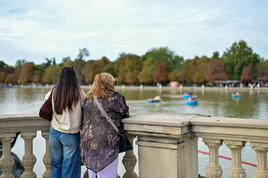Back view of unrecognizable Mother and Daughter Adiring the Lake View in El Retiro Park, Madrid
