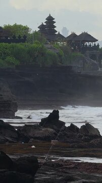 Verdant Tanah Lot Temple Scenery. Green Landscape With Distant Spires. Vivid Foliage Surrounds Coastal Temple Views. Serene Natural Setting With Distant Shrine Peaks And Lush Greenery,Bali island