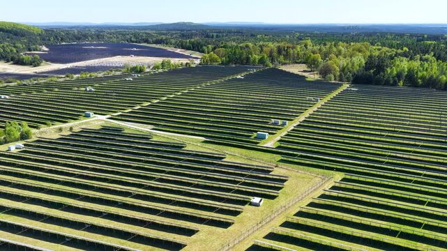 Solar panels generating renewable green energy and electricity in a wide open field, modern clean power technology infrastructure for sustainable energy production, environmental conservation