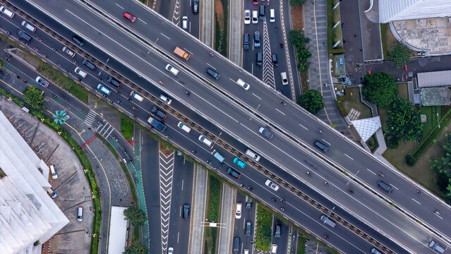 Urban aerial photography of Jakarta multilayer highway roads with traffic congestion, vehicles and modern city infrastructure