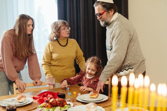 Jewish family celebrating hanukkah holiday at home