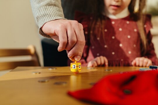 Hand spinning dreidel playing traditional hanukkah game