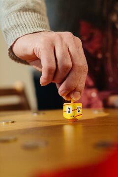 Hand spinning dreidel playing hanukkah game