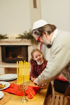 Grandfather and child celebrating hanukkah at home