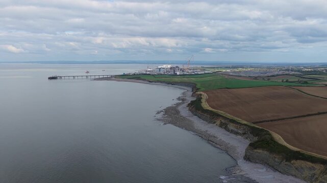 Aerial View of a Coastal Nuclear Power Station Beside Fields and Water