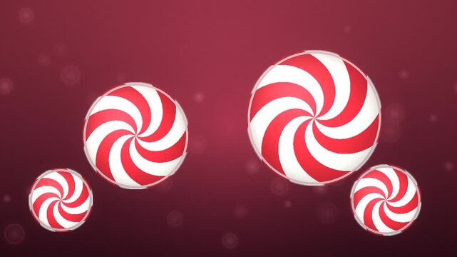 Red and white striped peppermint candies spinning smoothly against a dark maroon background with glowing particles floating gently in the holiday season atmosphere