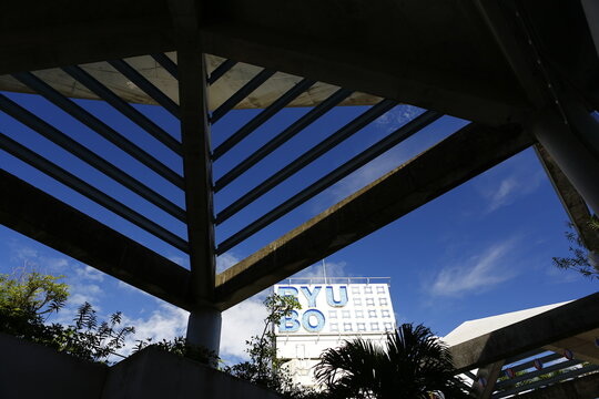 A low angle view of the RYUBO department store sign framed by modern architecture.