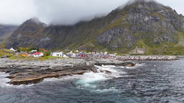 Traditional wooden structures drying skrei cod in Lofoten Islands, Norway, create a captivating scene