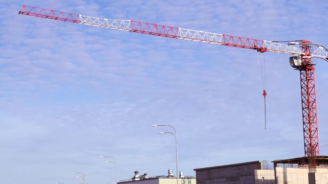 Tower Crane at Construction Site Against a Cloudy Sky