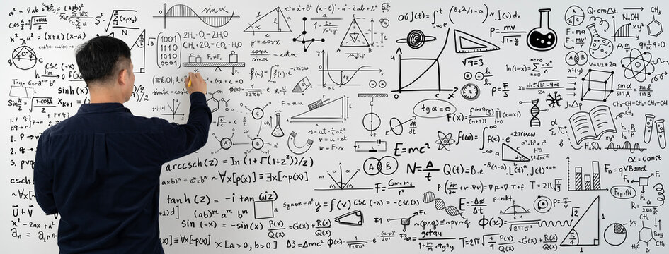 Scientist or student solving mathematical and physics problems on whiteboard