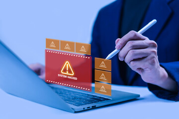 Cybersecurity concept featuring a laptop user, digital warning alerts, and a system hack notification, illustrating data breaches, cyber attacks, online threats, and information security risks. © WICHAI