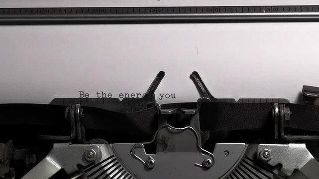 Vintage typewriter typing Be the energy you want to attract positive vibes quote footage