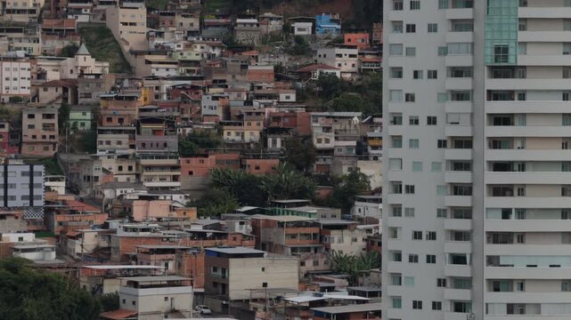 White Residential Tower Rising Above Dense Hillside Favela