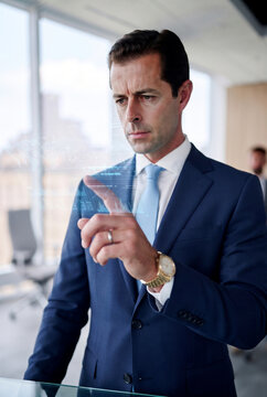 Businessman using holographic interface in modern office