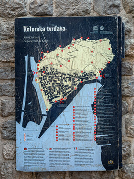 KOTOR, MONTENEGRO &ndash; SEPTEMBER 1, 2026: Information map of Kotor Fortress mounted on a stone wall, showing fortifications, bastions and points of interest within the UNESCO Old Town.
