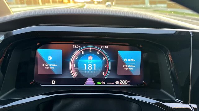 Driver's point of view of a car speeding down a highway with the digital dashboard in focus