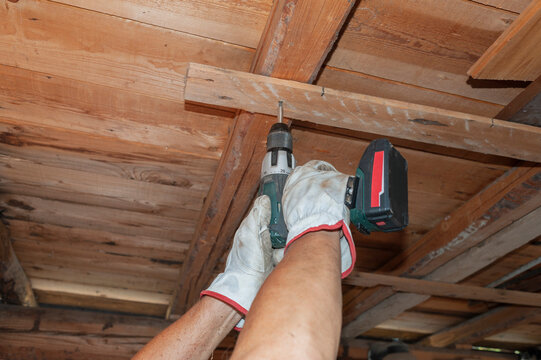 Cordless Drill Used on Wooden Ceiling Beam