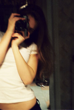 Taking a selfie in a home setting during evening