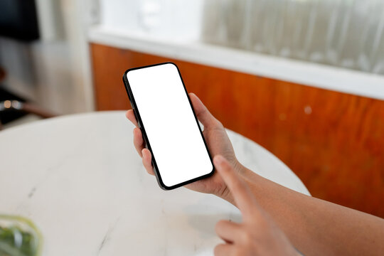 Person holding smartphone with blank white screen mockup