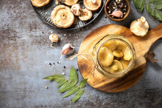 Pickled mushroom jar with fresh mushroom and spice
