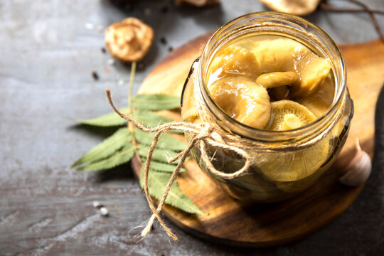 Pickled mushroom in glass jar for seasonal cooking