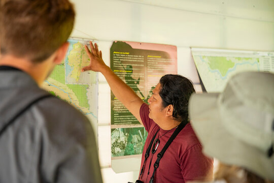 Tour guide explain Amazon Jungle map to explorer group