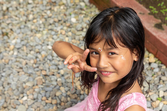 Young Hindu girl in pink dress at colorful festival