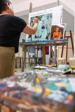 Woman paint portrait artwork during art lessons in studio