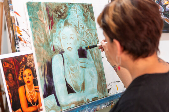 Woman take painting lessons in an art studio