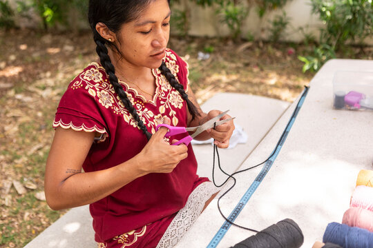 Artisan woman create handmade macrame textile outdoors