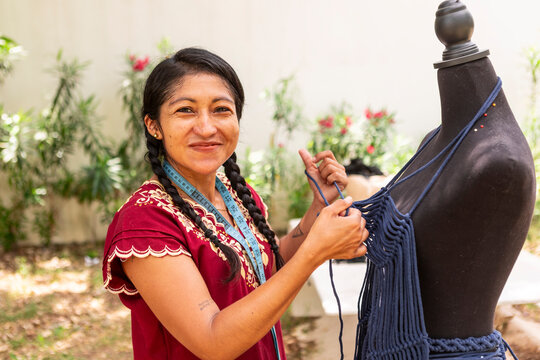 Artisan create macrame garment on dress form