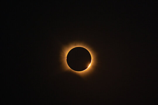 Solar eclipse over reservoir at sunset in Spain