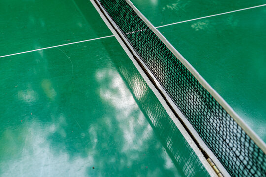 Padel court net on green playing surface from above