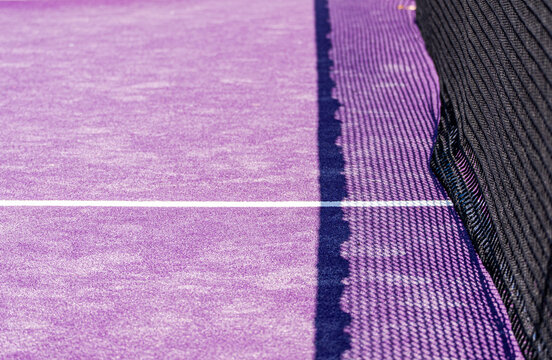 Purple tennis court and net with white boundary line