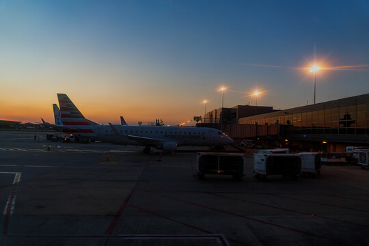 Travel and History: American Airlines Aircraft Parked at Gate During Sunset with Control Tower at Washington Dulles International Airport