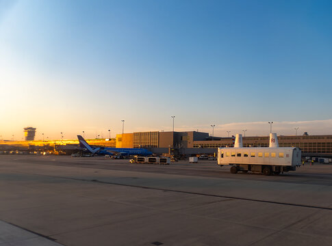 Travel and History: White Mobile Lounge Passenger Transfer Vehicle Driving on Tarmac at Washington Dulles International Airport