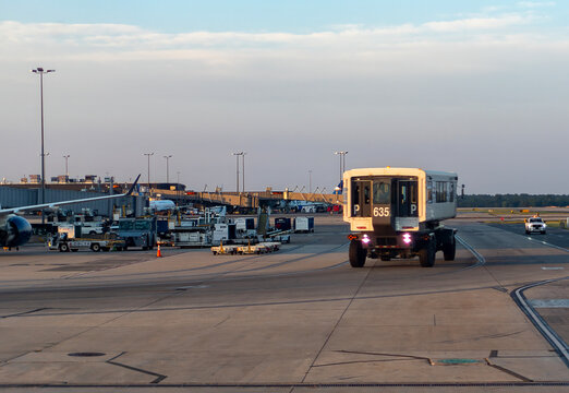 Travel and History: White Mobile Lounge Passenger Transfer Vehicle Driving on Tarmac at Washington Dulles International Airport