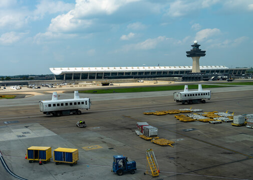 Travel and History: Iconic Eero Saarinen Main Terminal and Air Traffic Control Tower with Mobile Lounges on Tarmac at Washington Dulles International Airport
