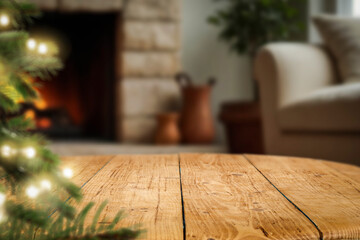 Fototapeta premium Christmas product background with wooden table and copy space – cozy home interior with glowing fireplace