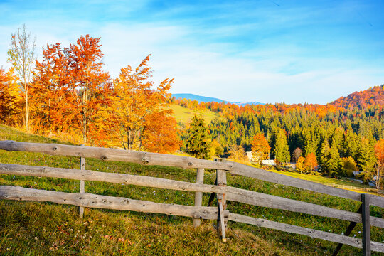 Romania countryside on autumn evening. mountain scenery with wooden fence through hill. rural life in remote area of Apuseni natural park