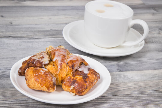 Croissants from polish city Poznan baked according to traditional recipe with poppy seed filing and cup of coffee