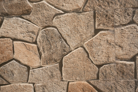 Irregular natural stone wall forms durable masonry pattern linked with vernacular architecture resilient construction heritage design thermal mass local materials character and timeless building.