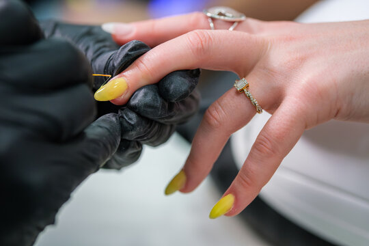 Professional beauty salon service featuring a manicure, nail art, gel polish, nail polish application, a manicurist, and a nail technician during a detailed nail care session