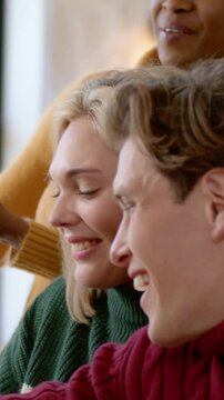Vertical video: Passing host in yellow knit sharing food at home table with woven basket