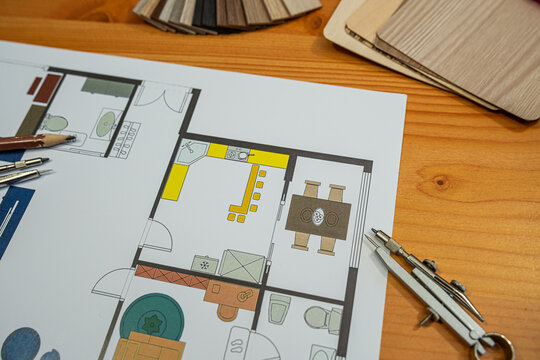 Close up of Architectural Floor Plan Blueprint with Wooden Material Samples and Compass Desk