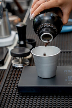 Coffee beans are measured for espresso at a professional caf&eacute; workstation.