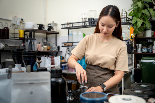 Small business owner working at a coffee station with professional tools.