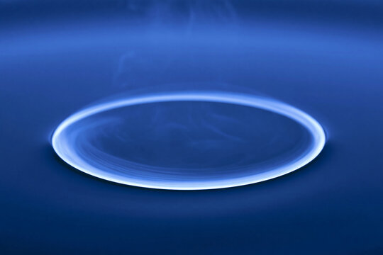 Ring shaped vortex of dye travelling through water, physics phenomenon macro detail