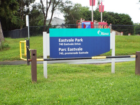 Gloucester, Ontario, Canada &ndash; August 3, 2026: A blue and teal "Eastvale Park" sign stands on green grass with a playground set visible in the background on at 740 Eastvale park.