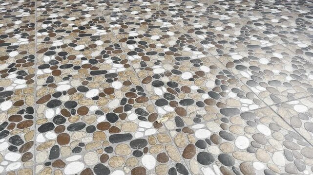 Polished pebble stone tile flooring texture background